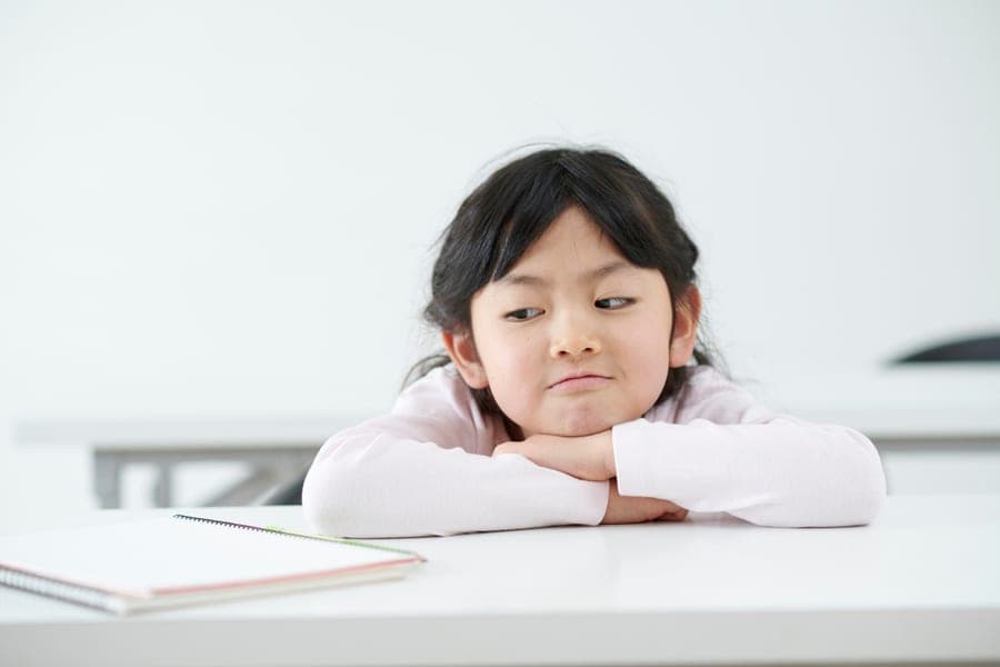 A student feeling disengaged in a conventional classroom