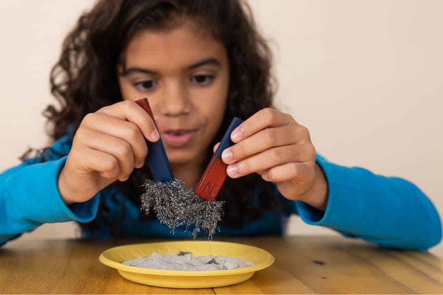 A child exploring magnets during a KidsWow learning session